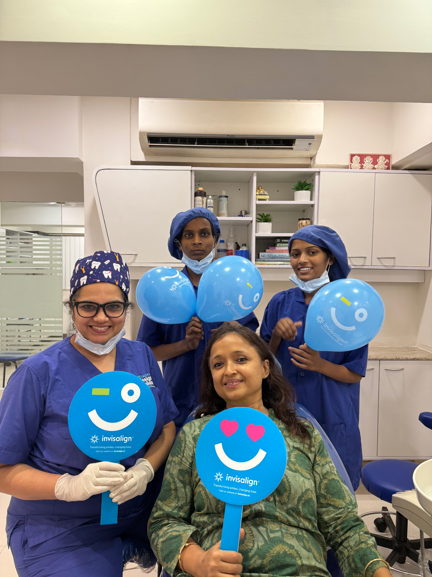 Designer Smiles team celebrating an Invisalign patient