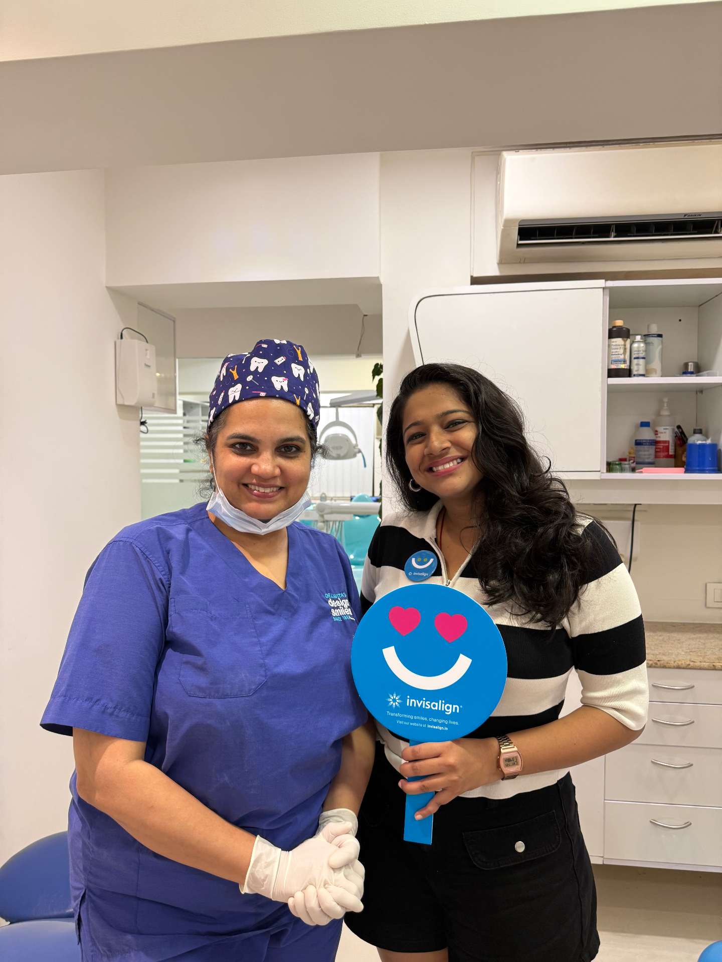 Happy Invisalign patient with Dr. Kavita at Designer Smiles
